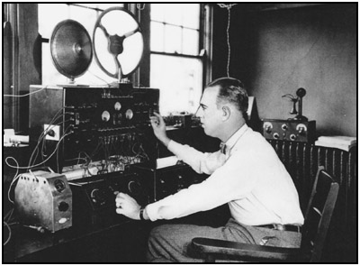 Powel Crosley, sometime in 1926, testing one of his latest radios in a lab room of his factory